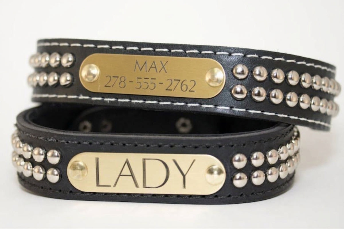 Two black handmade studded leather dog collars with custom engraved brass name plates