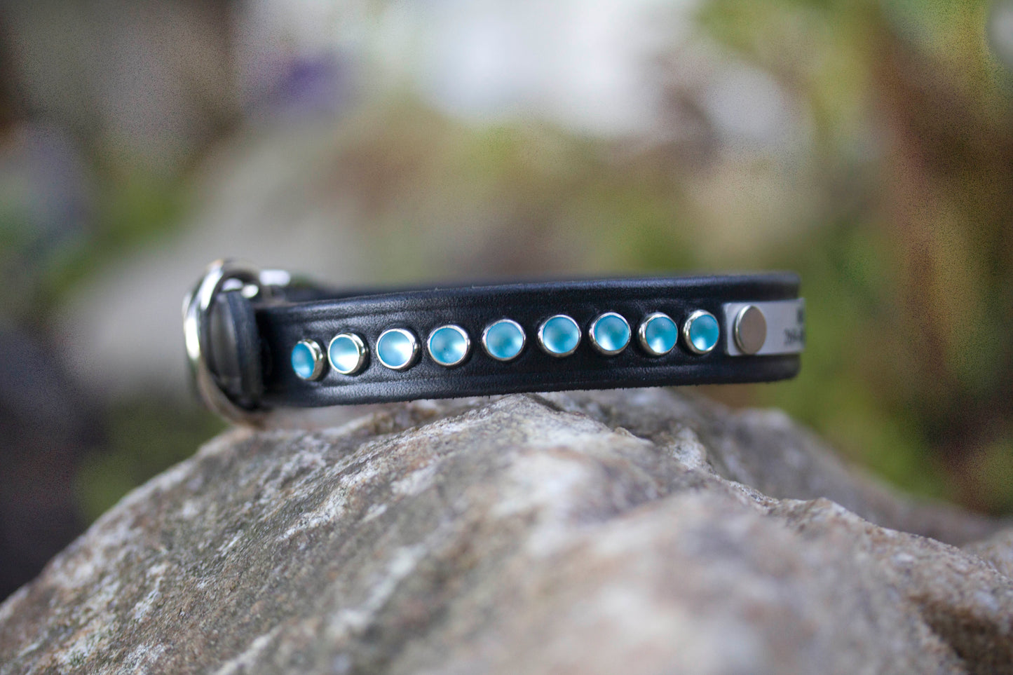 D-ring end of black latigo leather dog collar with blue cabochon studs by Kippy and Co