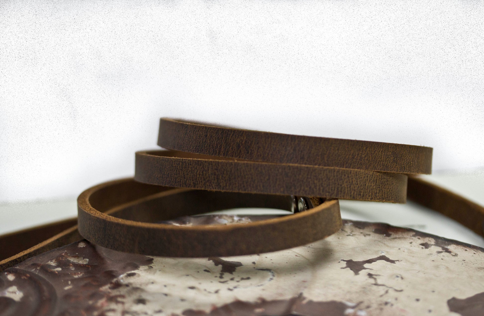 Heritage leather dog leash coiled on vintage metal frame - premium natural leather made in USA