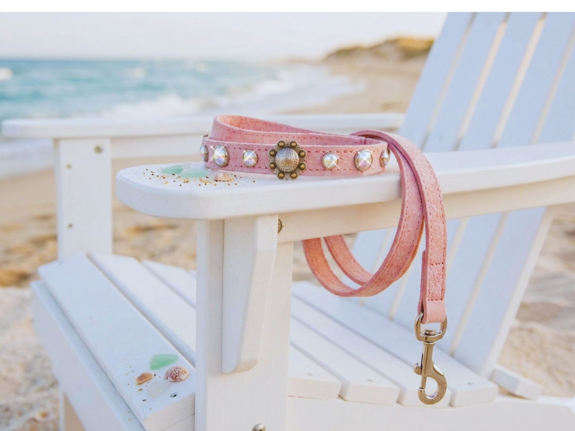 Matching pink ostrich leather dog collar and leash set draped over beach chair - handmade in USA