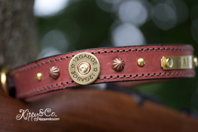 Leather Dog collar with 12 gauge shotgun shell conchos, brass spots, copper parachute spots and a personalized name plate