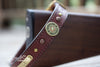Leather Dog collar with 12 gauge shotgun shell conchos, brass spots, copper parachute spots and a personalized name plate